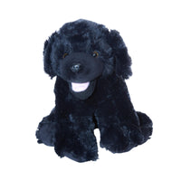 A black dog stuffed animal sitting on a white background.