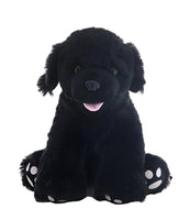A large black stuffed dog toy with white paw prints on its feet.