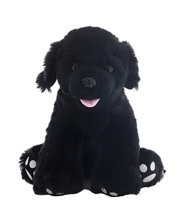 A large black stuffed dog toy with white paw prints on its feet.