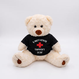 A white teddy bear wearing a black t-shirt with the text "Emotional Support Bear" printed on it.