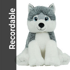 A plush toy of a husky dog with a gray and white fur coat and blue eyes, sitting on its hind legs.