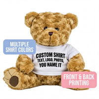 A brown teddy bear wearing a white t-shirt with text printed on it.