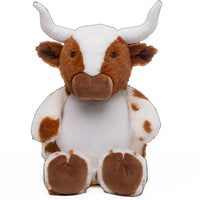 A stuffed toy cow with large white horns and a white belly.