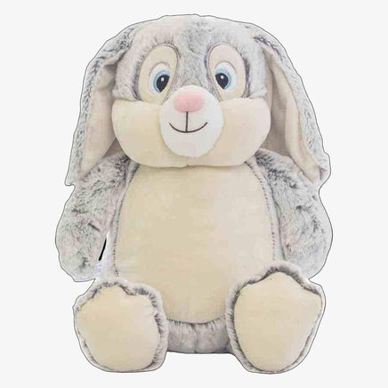 A plush toy of a rabbit with large eyes and a big smile.